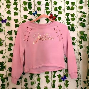 Graphic sweatshirt with criss cross ribbons.